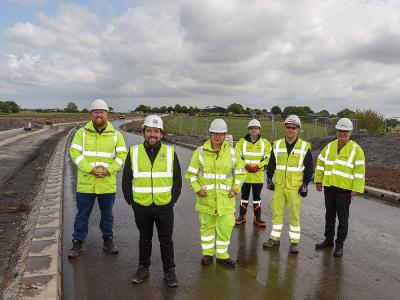 Council Leader Councillor David Baines, Deputy Council Leader Councillor Seve Gomez-Aspron and Councillor Andy Bowden on part of the new Parkside Link Road with members of the delivery team