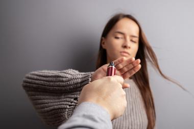 Woman holding her hand up to reject someone offering her a vape