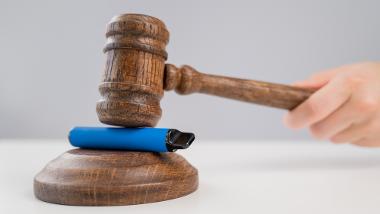 A vape being hit by a wooden gavel