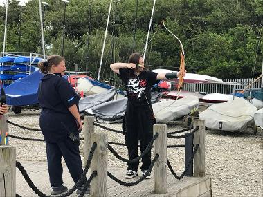 Children and young people participating in problem solving games and an archery session