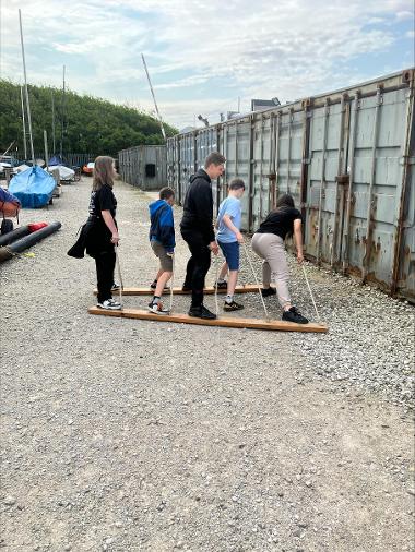 Children and young people participating in problem solving games and an archery session