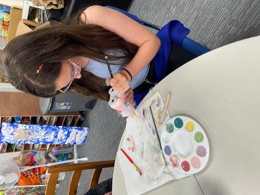 Children and young people enjoying Pottery Painting sessions